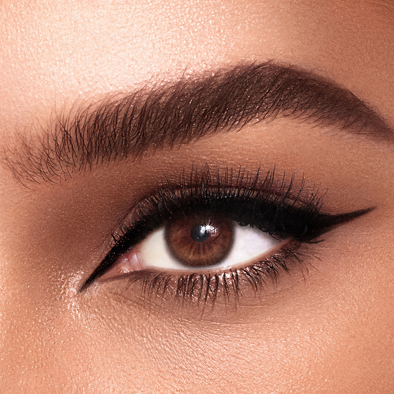 Disney 100  x Charlotte Tilbury limited-edition Charlotte's Magic Cream with Tinkerbell design on night sky backdrop
