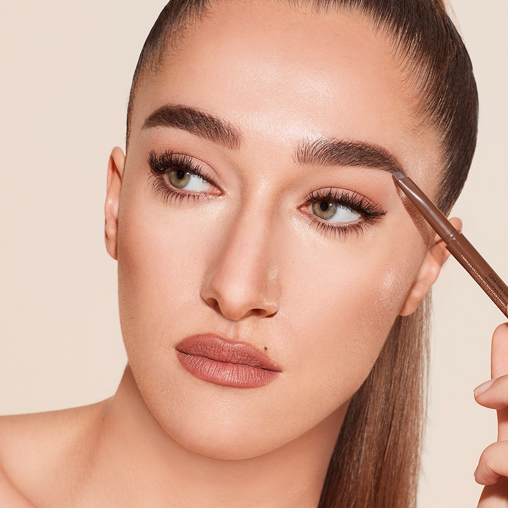 Disney 100  x Charlotte Tilbury limited-edition Charlotte's Magic Cream with Tinkerbell design on night sky backdrop