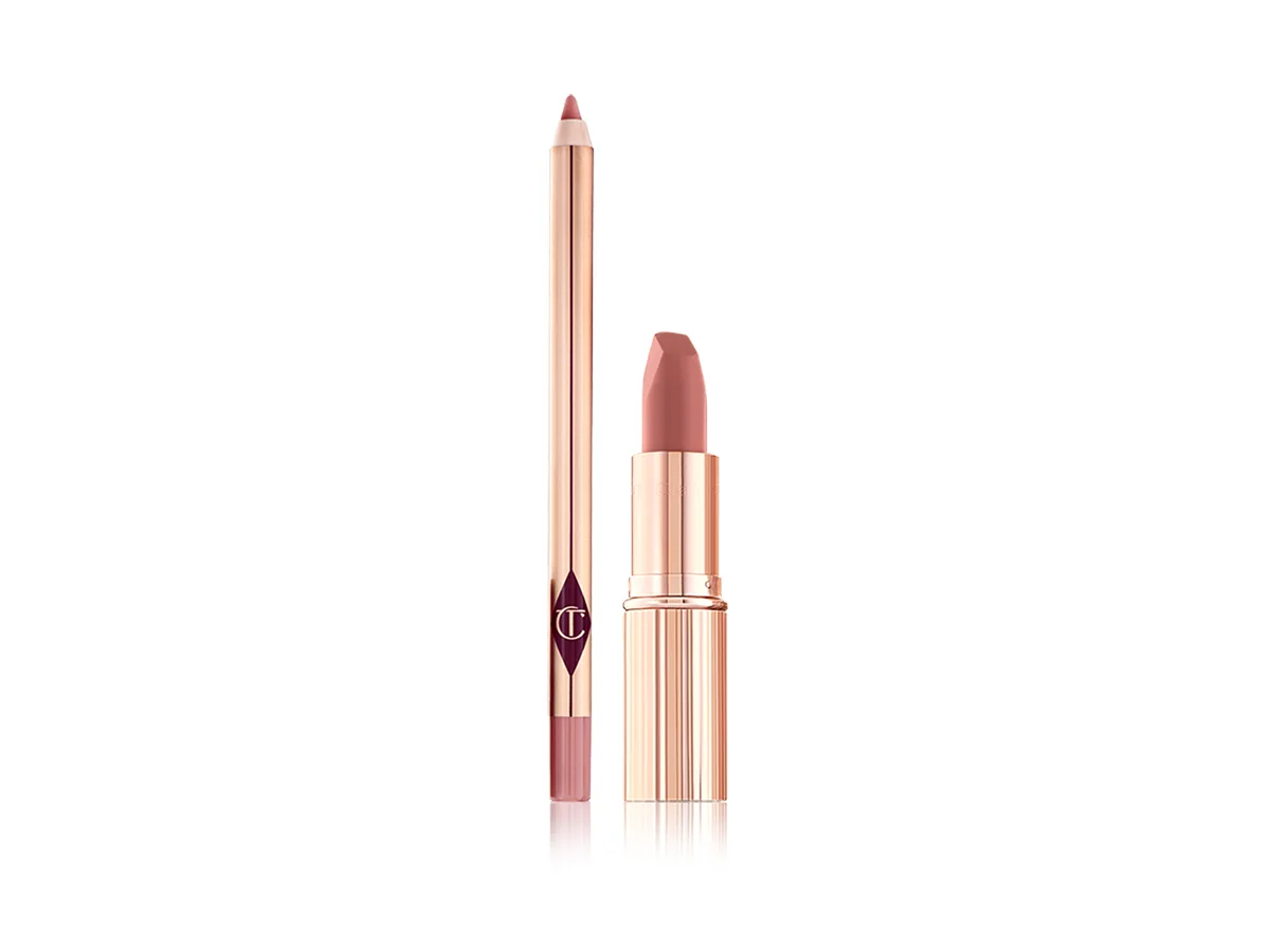 An open nude pink lip liner pencil with an open nude pink matte lipstick, both in golden-coloured packaging. 