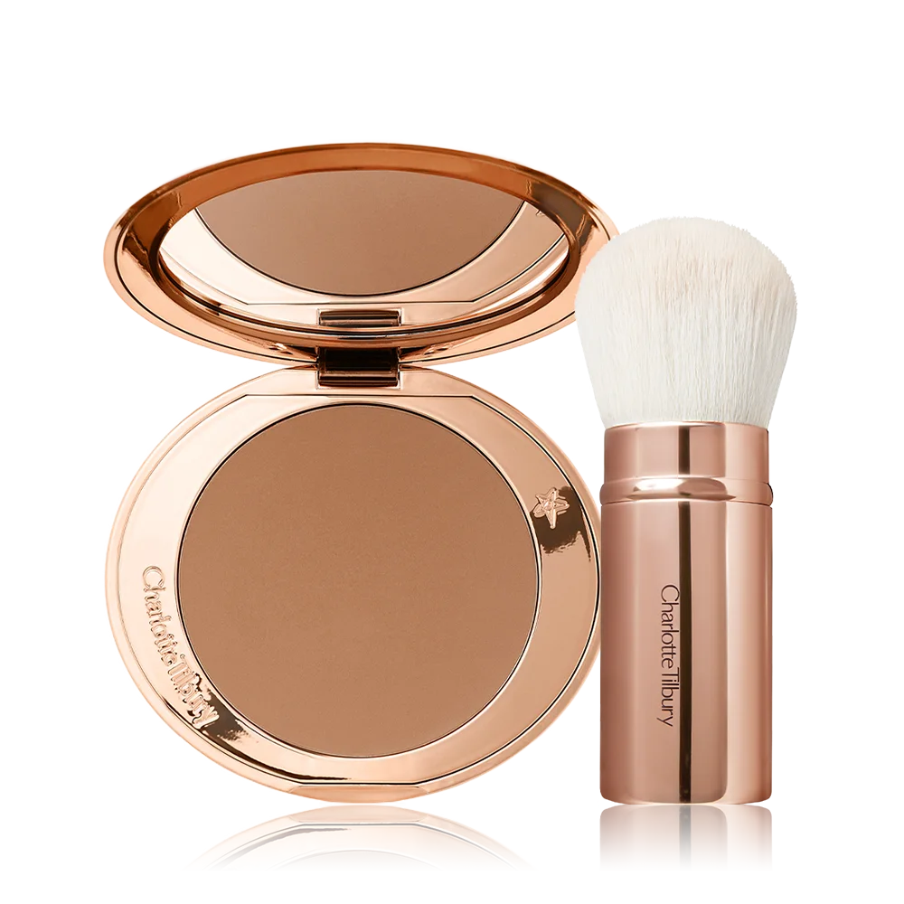 An open bronzer compact in a light brown shade and a kabuki brush with white-coloured bristles and a gold-coloured handle. 