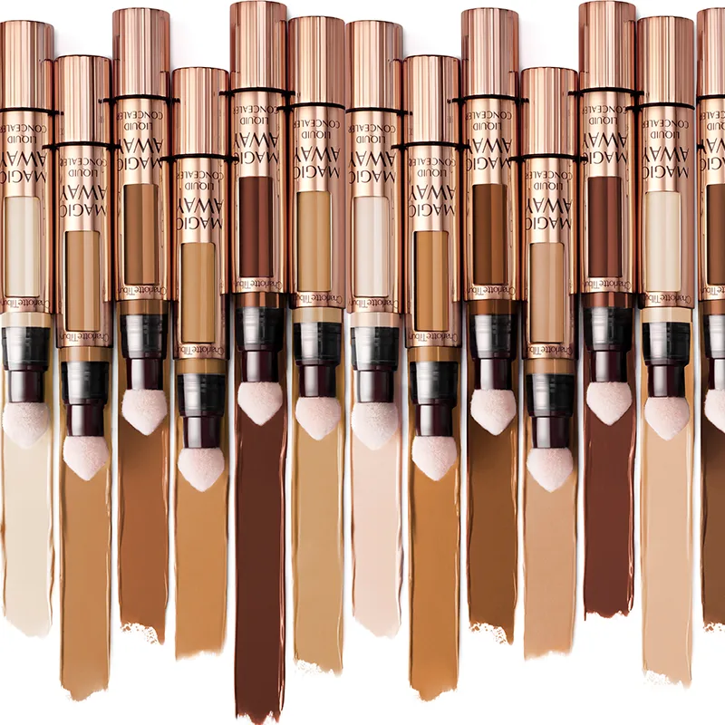 An array of liquid concealers, set next to each other, with swatches in fair, medium, and deep tones. 