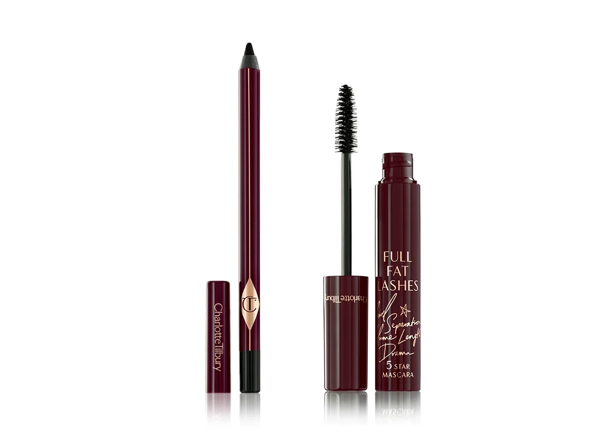 An open eyeliner pencil in a shimmery brown shade with its cap next to it and an open mascara in dark crimson packaging with its applicator next to it. 
